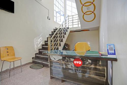 a glass counter in a room with a staircase at OYO Flagship Hotel Midtown 2 in Noida