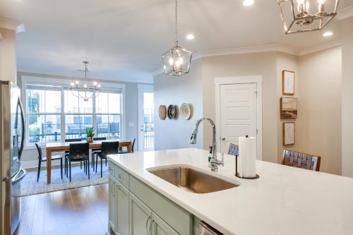 a kitchen with a sink and a dining room at Cozy South Carolina Abode - Steps from Main Street in Greenville