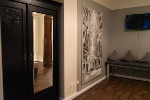 a hallway with a mirror and a couch in a room at Rein Klassik Hotel in Bad Pyrmont