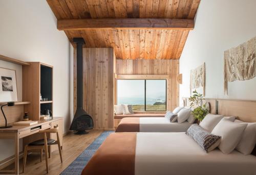 two beds in a room with a view of the ocean at The Sea Ranch Lodge in Sea Ranch