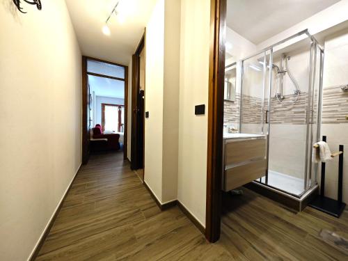 La salle de bains est pourvue d'une douche à l'italienne et d'un lavabo. dans l'établissement Hostdomus - City Center Apartment, à Sestrières