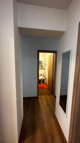 an empty room with a hallway with wood floors at Japandi apartamentai in Kaunas