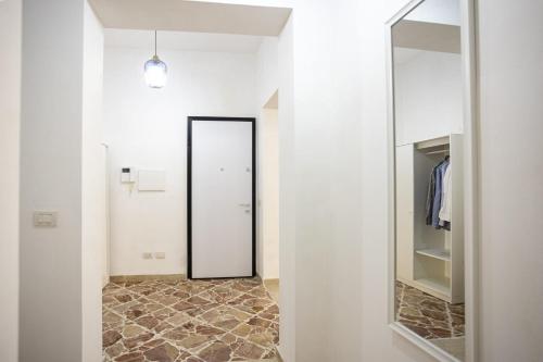 a hallway with a mirror and a walk in closet at Al 26 Apartment in Erice