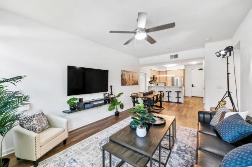 a living room with a couch and a tv at Beverly Grove Chic City Oasis 2 BR Apt with Den 138 in Los Angeles
