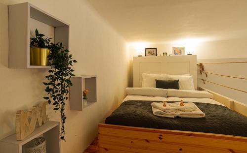 a bedroom with a bed with towels on it at Magica - Cosy Apartment in the heart of Budapest in Budapest