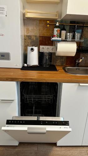 a kitchen with a stove top oven under a counter at Japandi apartamentai in Kaunas