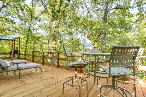 a deck with chairs and a table and chairs at Dog-Friendly Kingston Cabin with Wraparound Deck! in Kingston