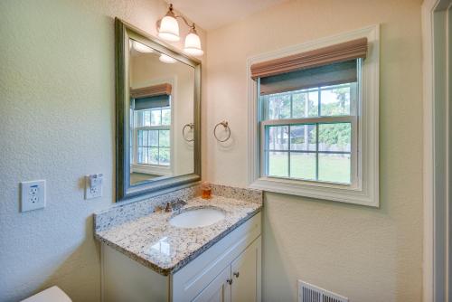 a bathroom with a sink and a mirror at Chesapeake Vacation Rental about 9 Mi to Norfolk! in Chesapeake
