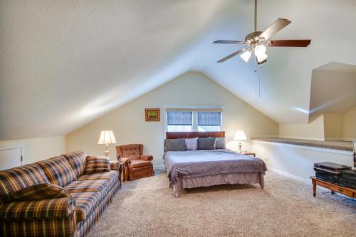 a bedroom with a bed and a couch and a ceiling fan at Chesapeake Vacation Rental about 9 Mi to Norfolk! in Chesapeake