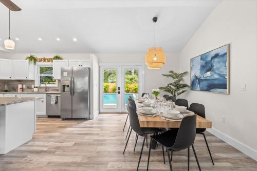 a kitchen and dining room with a table and chairs at Heated Salt Pool, Arcade, 2 Kings, Near Ami, Img in Bradenton