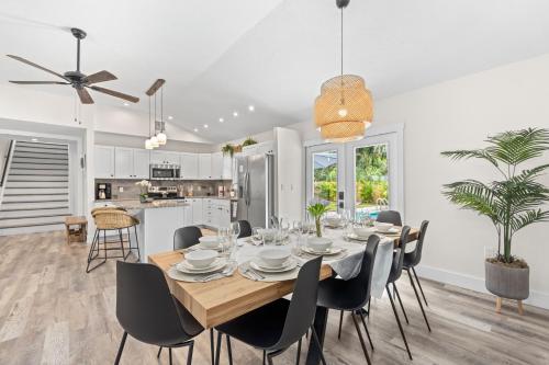 a dining room and kitchen with a table and chairs at Heated Salt Pool, Arcade, 2 Kings, Near Ami, Img in Bradenton