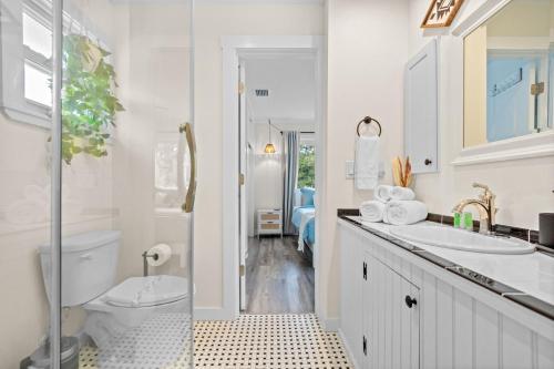 a white bathroom with a toilet and a sink at Private Heated Pool - Arcade - Pets - 2 King Beds in Bradenton