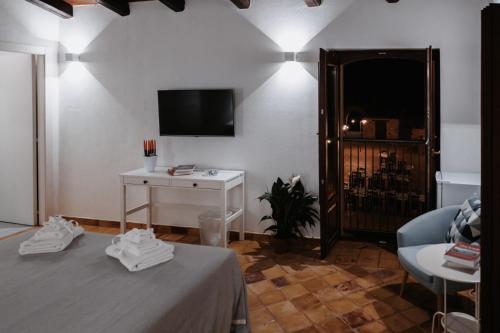 a room with two tables and a tv and a table with shoes at Agriturismo Fattoria San Sebastiano in Strongoli