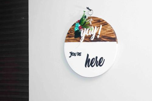 a sign that says you are here hanging on a wall at Cozy & tranquil 1 Bedroom dainty haven in Kampala in Buwate