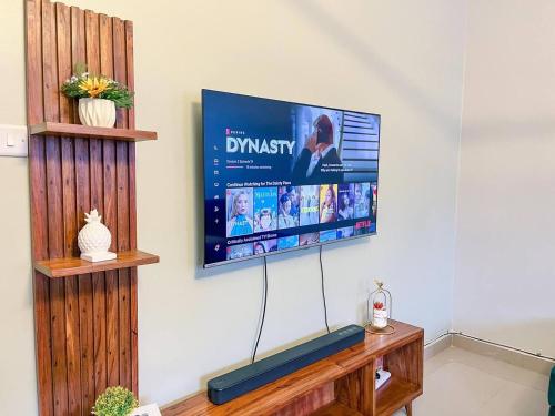 a flat screen tv hanging on a wall at Cozy & tranquil 1 Bedroom dainty haven in Kampala in Buwate