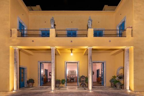 an external view of a building with a balcony at Casa Cuseni, Patrimonio Culturale Immateriale UNESCO in Taormina