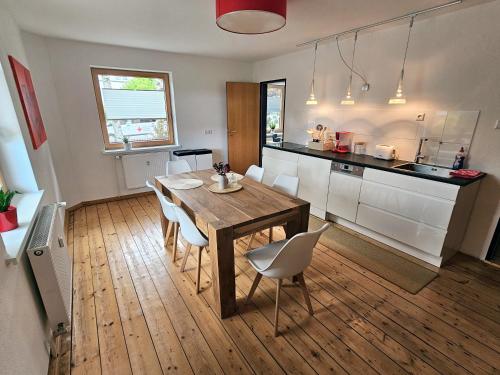 a kitchen and dining room with a table and chairs at Ferienwohnung im schönen Allgäu in Biessenhofen