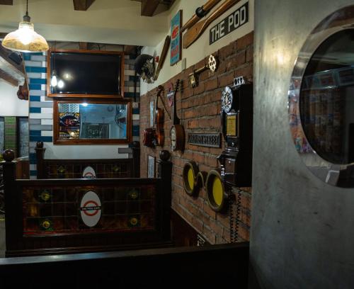 a room with a brick wall with a tv on it at The Liverpool Pod Travel Hostel in Liverpool