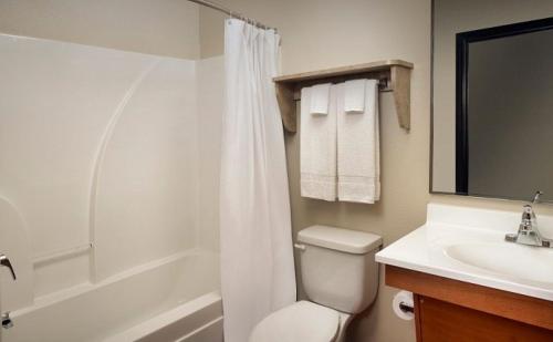 A bathroom at WoodSpring Suites Sioux Falls