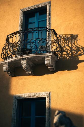 a balcony on the side of a building with a window at Casa Cuseni, Patrimonio Culturale Immateriale UNESCO in Taormina