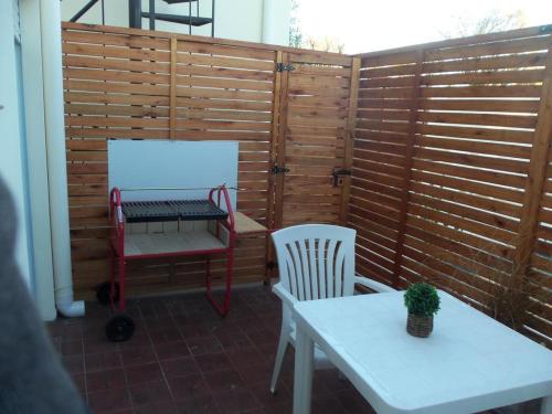 un patio con una valla, una mesa y sillas en Apart a metros de la laguna en Chascomús
