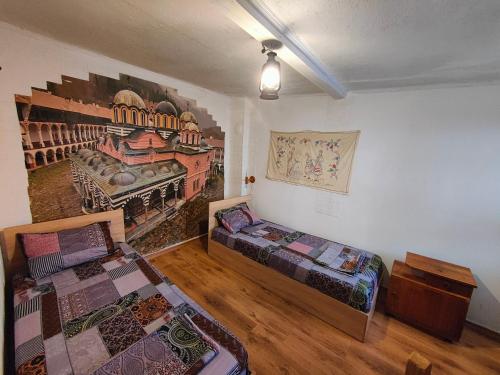 a room with two beds and a painting on the wall at 10 Coins Hostel & tours in Sofia