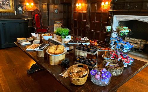 a table filled with lots of different types of food at The Castle at Skylands Manor in Ringwood