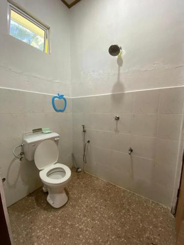 a bathroom with a white toilet in a room at Pelangi Homestay 1 in Bachok