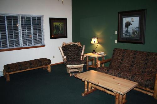 a living room with a couch and a coffee table at Timber Creek Chalets- 12 chalet in Estes Park