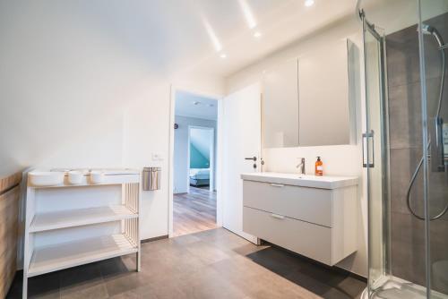 a bathroom with a sink and a shower at Big house with a view in Akureyri