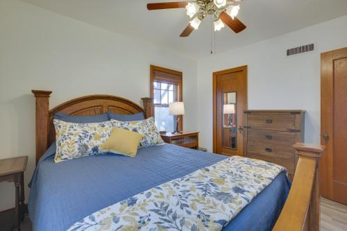 a bedroom with a blue bed and a ceiling fan at Glendive Getaway with Yellowstone River Access! in Glendive