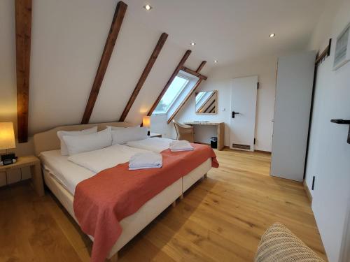 a bedroom with a large bed with a large window at Naturhotel Baltrum in Baltrum