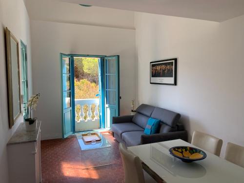 a living room with a couch and a table at Villa Jacqueline in La Seyne-sur-Mer