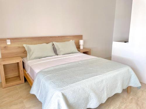a bedroom with a large bed with a wooden headboard at Beautiful 2 bedroom, pool, beach in Manta