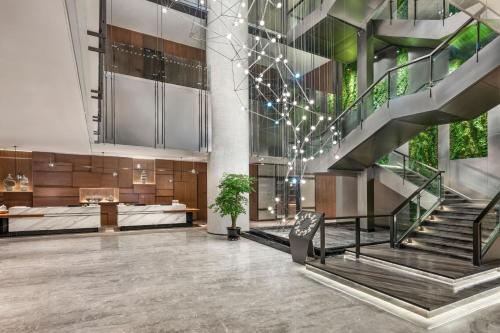 a lobby with a staircase in a building at Four Points by Sheraton Urumqi in Ürümqi