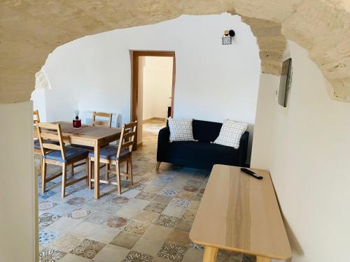 a living room with a table and a couch at Trulli Mamima in Martina Franca