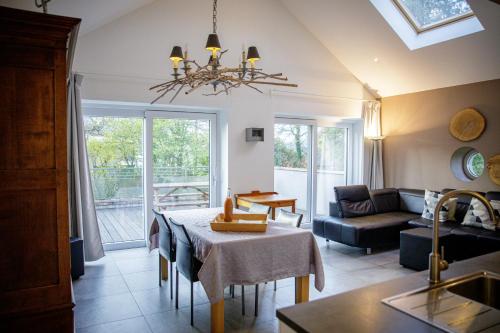 a living room with a table and a couch at Le gîte du Bois de Loo in Attert