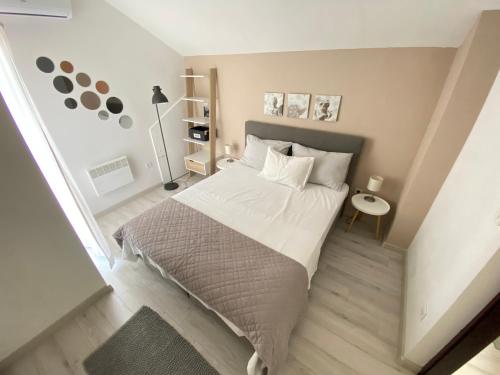 a bedroom with a large bed with white sheets at Apartments Flora 1 in Rab