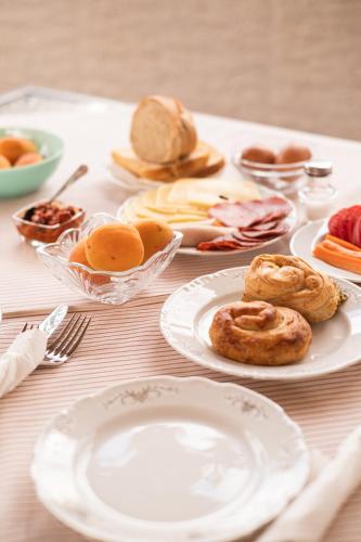 a table with plates of food on a table at Guesthouse Rose in Sarajevo