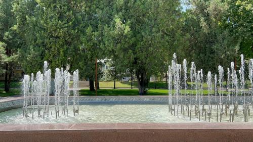a water fountain in the middle of a park at Hotel Ishonch in Samarkand