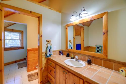 a bathroom with a sink and a mirror at Piney Creek Cabin with Deck, Grill and Mountain Views! in Piney Creek