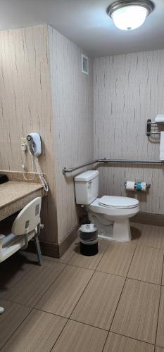 a bathroom with a toilet and a sink at Baymont by Wyndham Midland TX in Midland