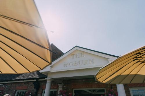 a building with a sign that reads the woolworth at The Woburn in Woburn