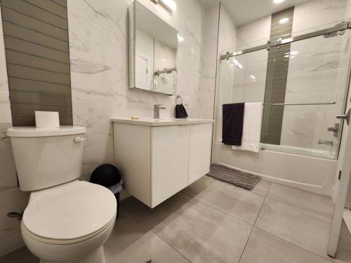 a bathroom with a toilet and a sink and a shower at Deluxe 2 Bedroom VIP to NYC in Union City