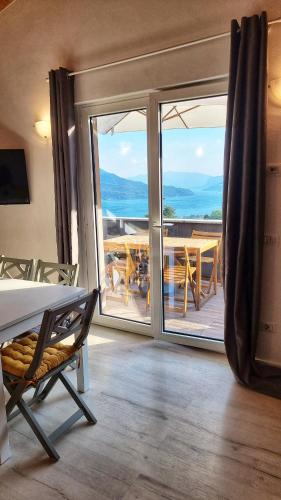 a bedroom with a balcony with a view of the ocean at REST AND VIEW APARTMENT in Vercana