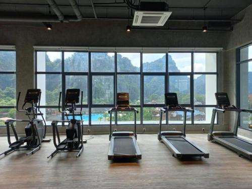 a gym with a bunch of exercise bikes in a room at Ipoh Sunway Villa , Guesthouse and Suites at Tambun, 6-14pax 2parking by IWH in Ipoh