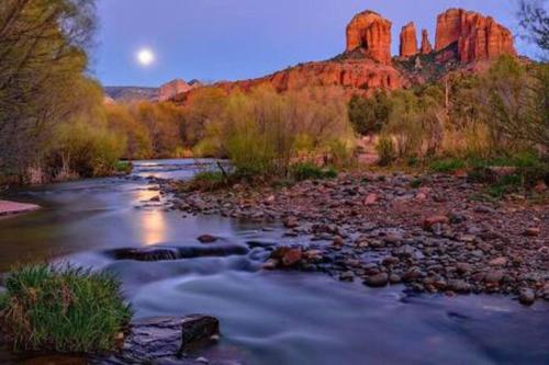 a river with rocks and a mountain in the background at DreamCatcher North Walk to Shop Dine Hike in Sedona