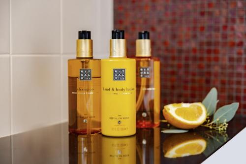 three bottles of essential oils and an orange slice at Crowne Plaza Amsterdam - South by IHG in Amsterdam