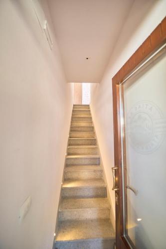 a staircase leading up to a door in a building at La Baita - Monte Amiata - in Castel del Piano