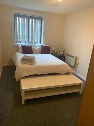 a bedroom with a large bed with a window at Luxury Stay with Sauna Gym and Pool in Leicester in Leicester